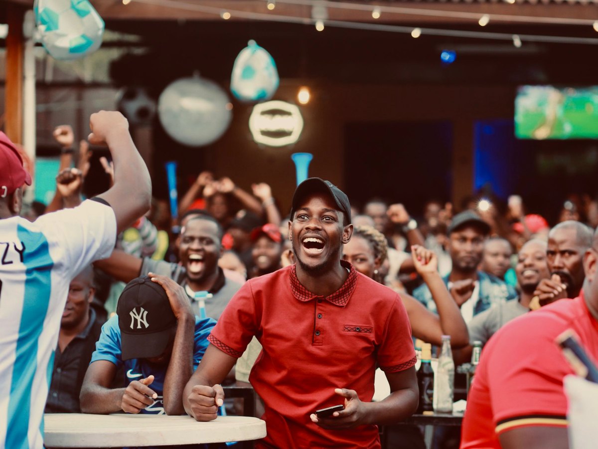 Friends celebrating a play at a sports bar